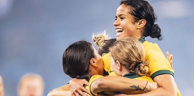 Matildas in a group hug