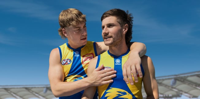 West coast Eagles players, one with his arm around the other