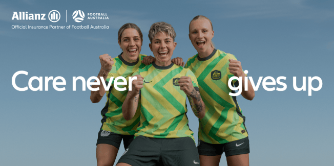 Three Football Australia players in green and gold jerseys stand together cheering, representing Allianz’s partnership with Football Australia under the message “Care never gives up”