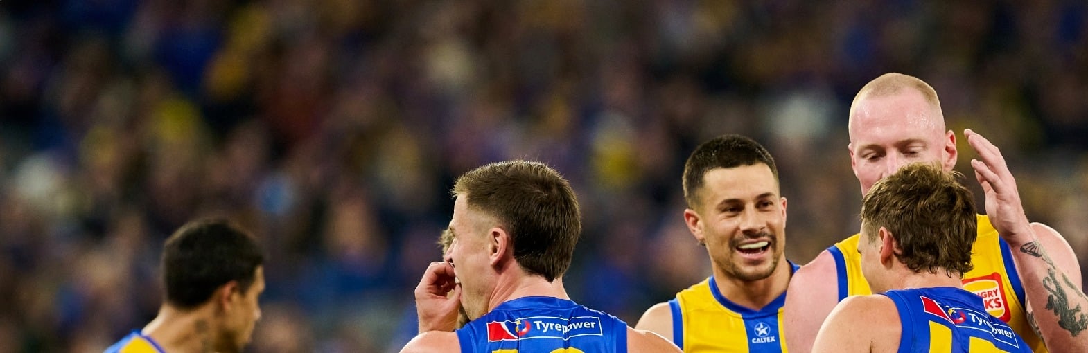 West Coast Eagles players celebrating on the pitch