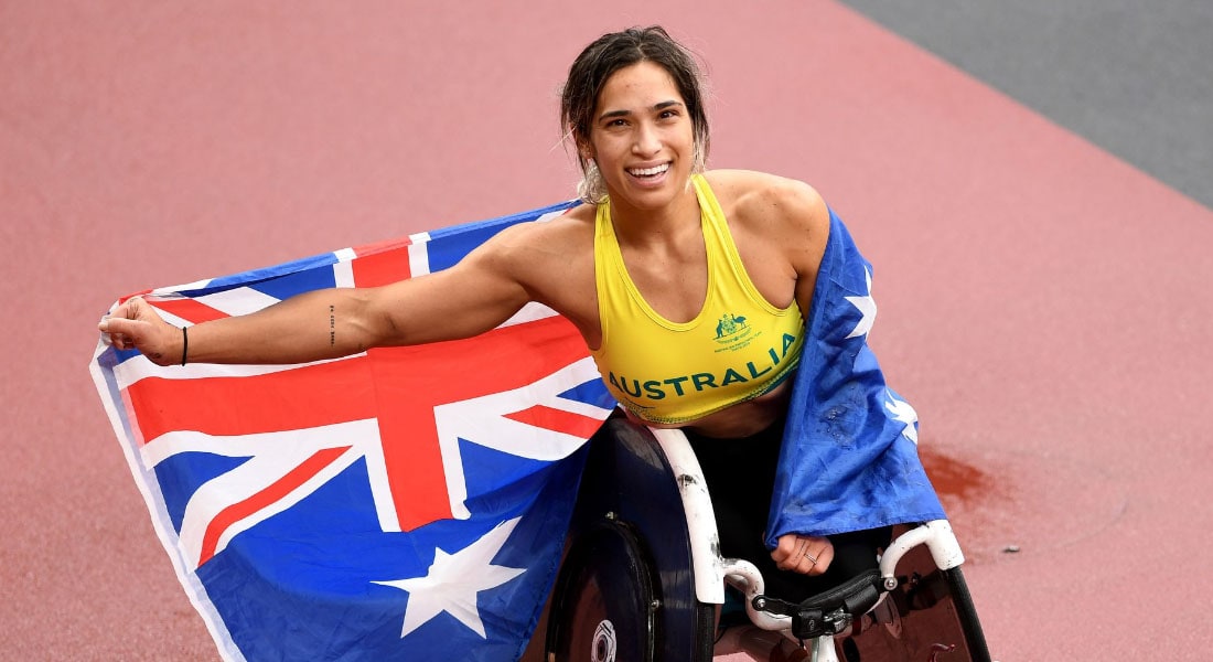 Madison de Rozario on the track draped in an Australian flag