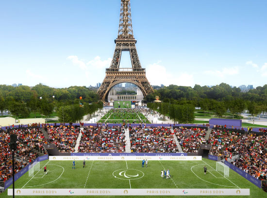 Crowds watching a soccer match in front of the Eiffel Tower