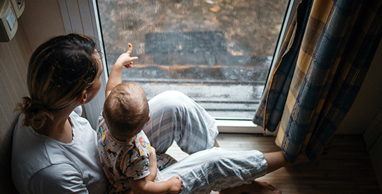 mother and child looking out of a window