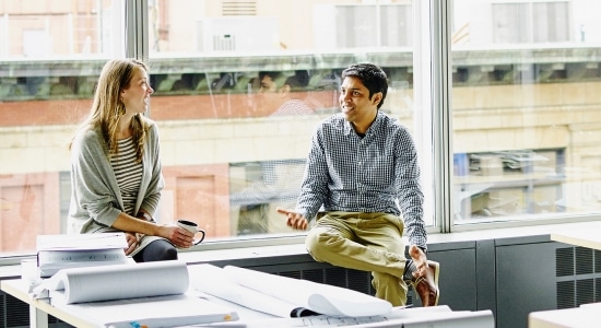 Man and woman chatting in the office