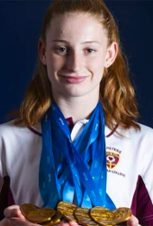 Childhood image of Mollie wearing multiple medals around her neck