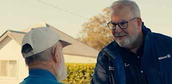 Scott Cooper, National Manager Disaster and Recovery  Allianz Australia shakes hands with a customer impacted by flooding