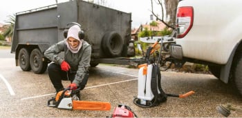A smiling women with a power tool