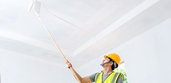 A person painting a ceiling