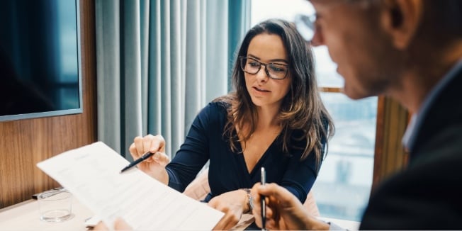 Broker and her client going through a document
