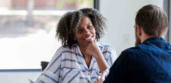 a man and woman smiling and chatting