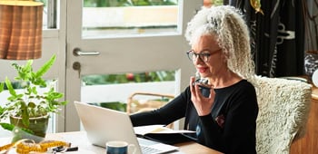 Woman sitting at her desk while using a laptop