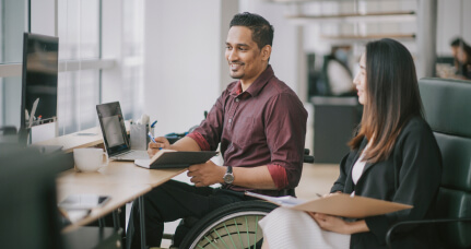 A women and a man in front of a desk