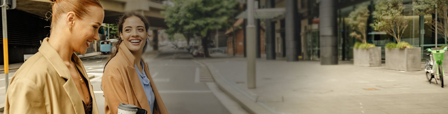 Two colleagues walking through the city with coffee