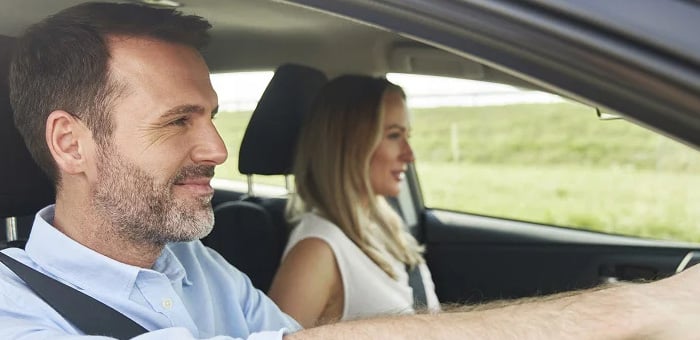 A man and a woman driving a car