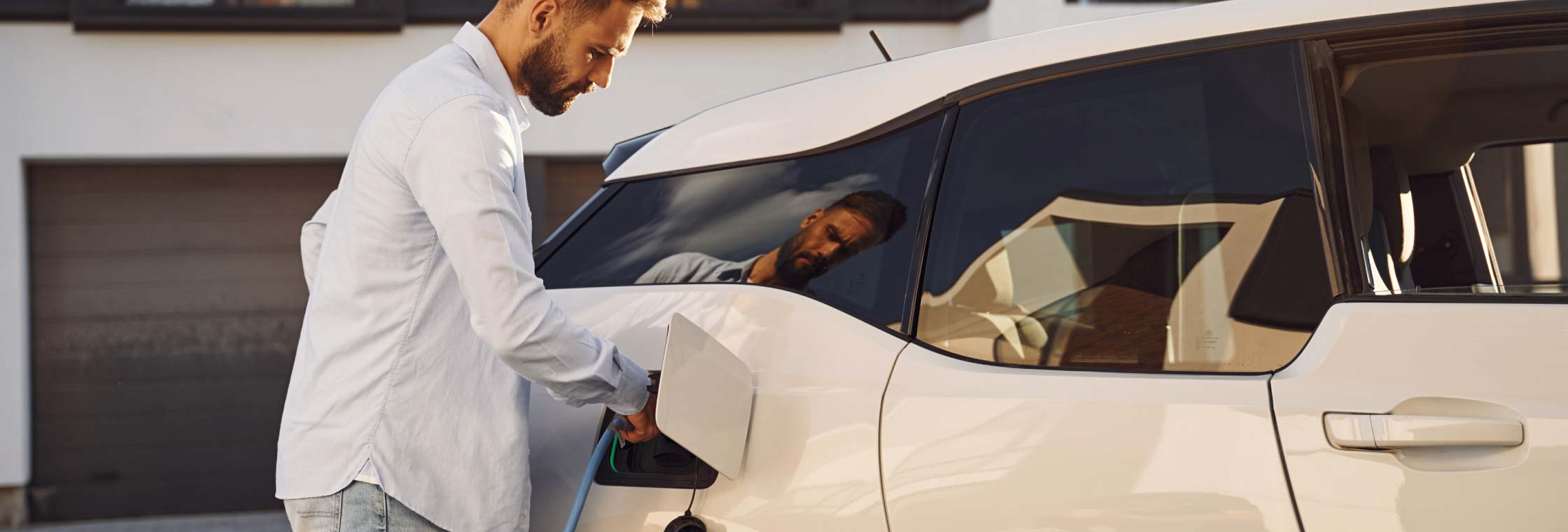 Person charging electric vehicle