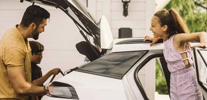 Family loading items into a vehicle