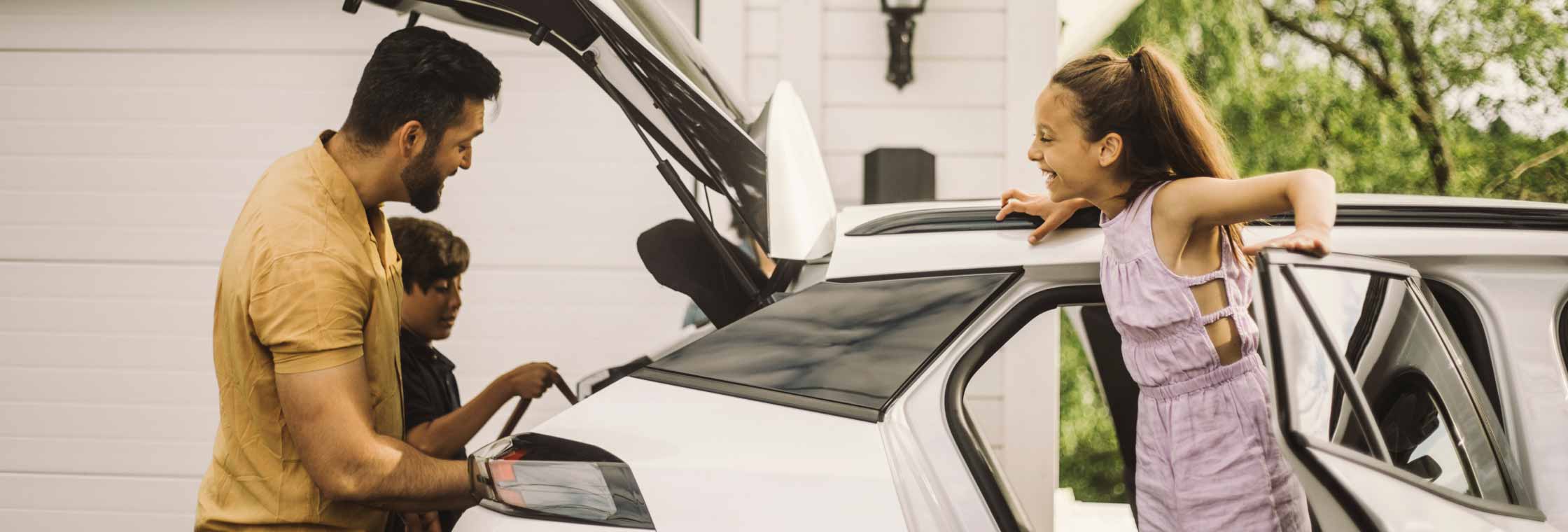 Family loading items into a vehicle