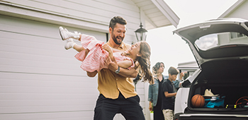 Man holding a young girl 