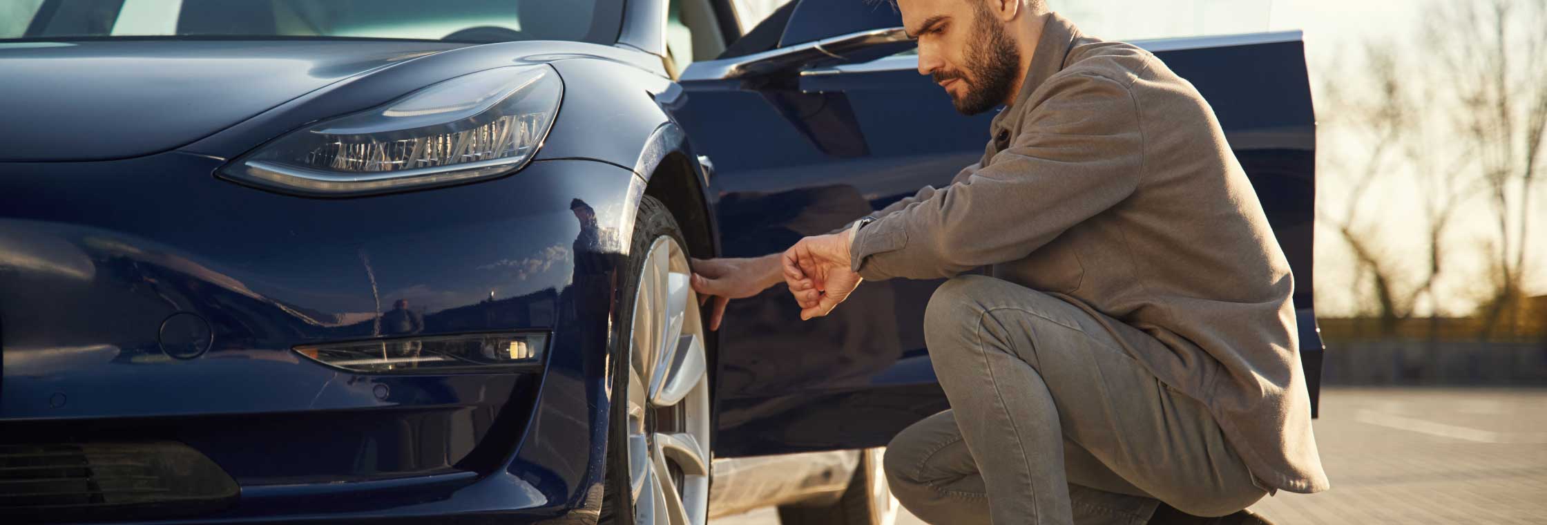 Male changing tyre on an electric vehicle