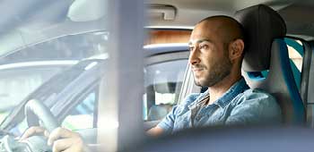 Man sitting in the driver's seat of an electric vehicle