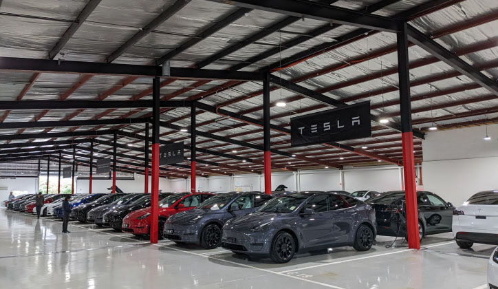 Tesla delivery and service centre in Australia showing Tesla Model Y ready for customer collection.