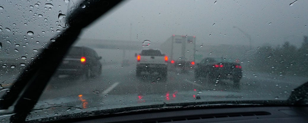 A driver’s view of a motorway in heavy rain while keeping a safe distance from the vehicle in front