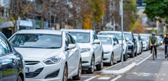 Cars parked along a busy urban street