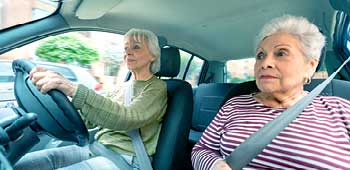 Senior female driving car with senior female passenger