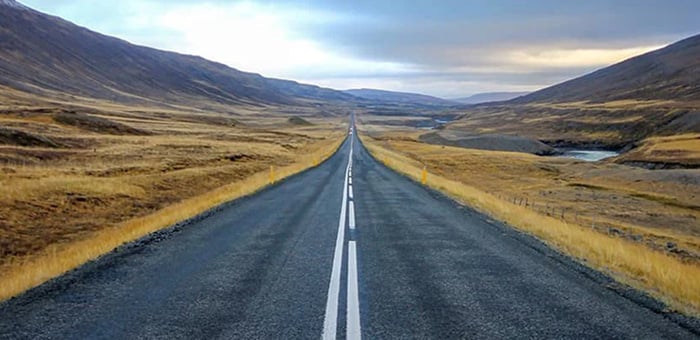 Long straight highway in rural mountainous setting
