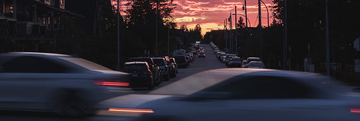 Cars driving on busy road at sunset