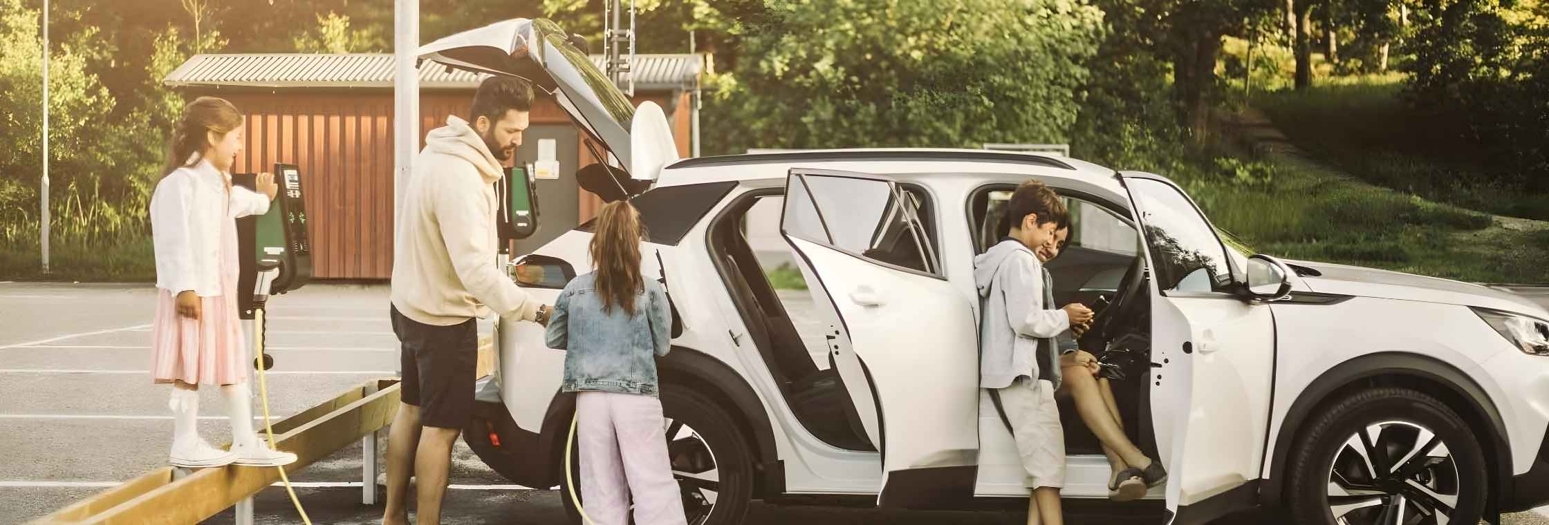 Family getting into an electric vehicle about to embark on their road trip