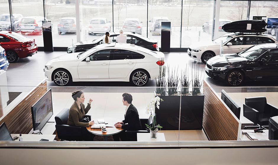 Man and woman in car dealership
