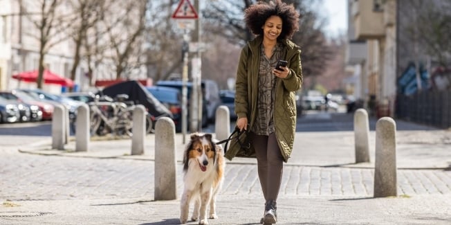 A woman walking her dog outside
