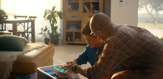 Father and son sitting on a couch packing an esky