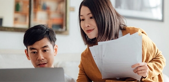 couple looking at laptop at home