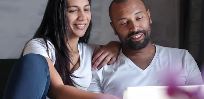 couple looking at laptop at home