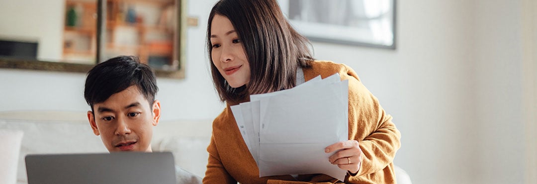 couple looking at laptop at home