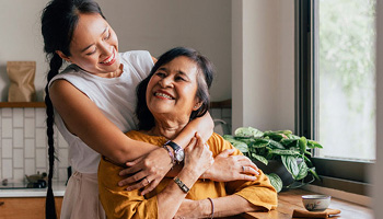 A mother and daughter hugging