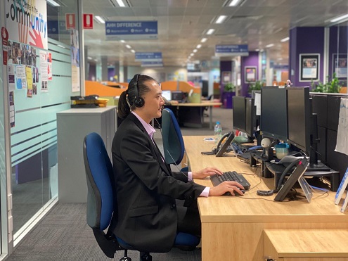 A man working at his desk in the call centre
