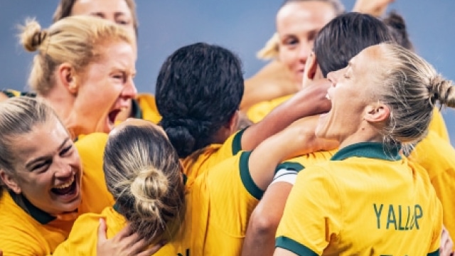 The Matildas in a celebratory group hug