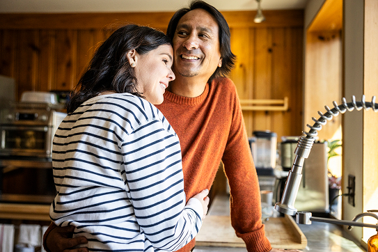 A couple in their kitchen at home.