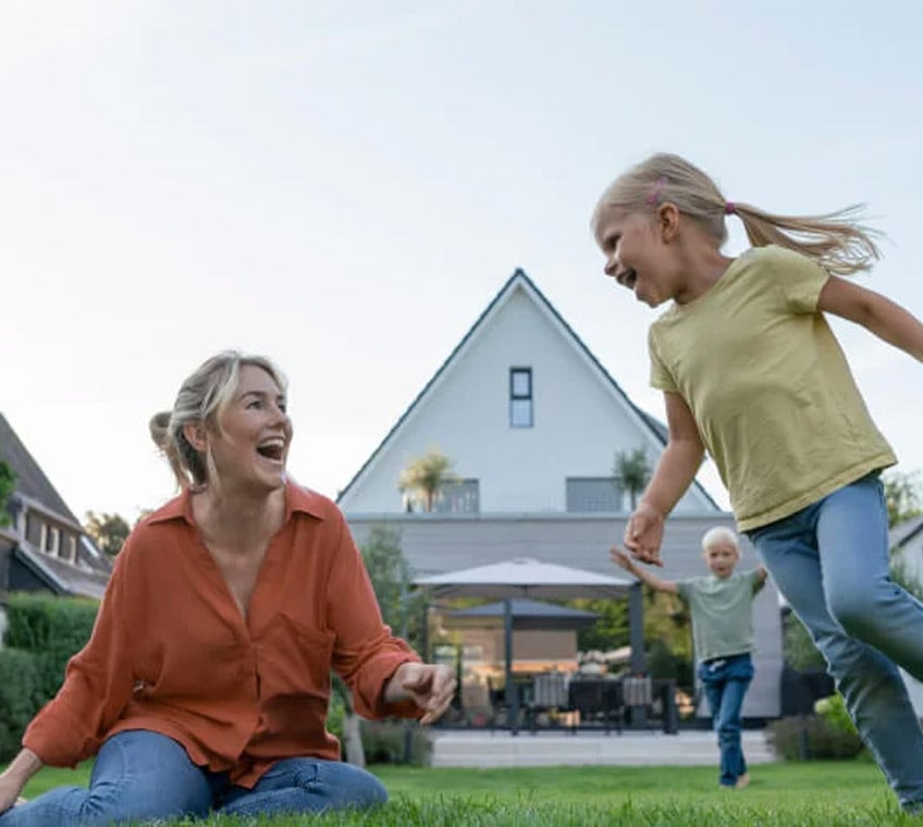 A family playing in the back garden of their home