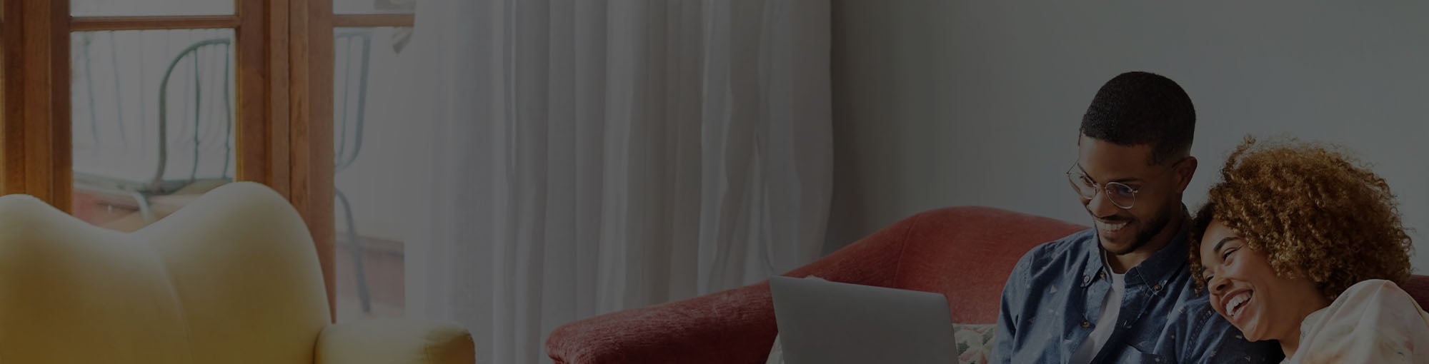 A man renewing his insurance on his laptop computer at home.