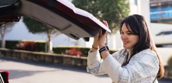lady shutting her car boot