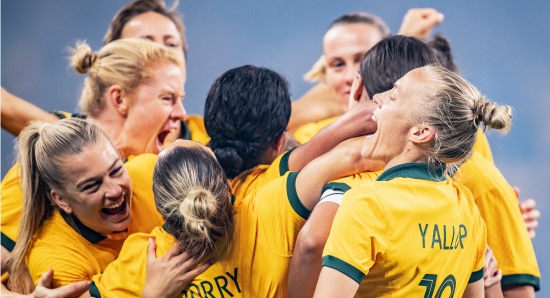 Matildas in a group hug