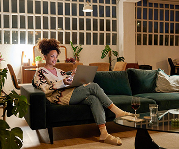 woman at home reading laptop