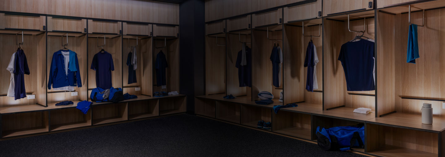 Interior of a locker room with sports clothing hanging up