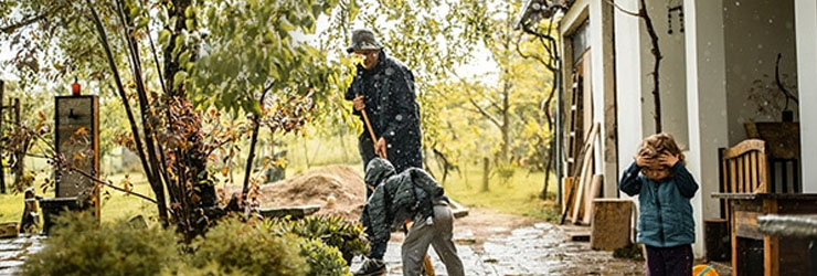 A father and his children clean up after a flood