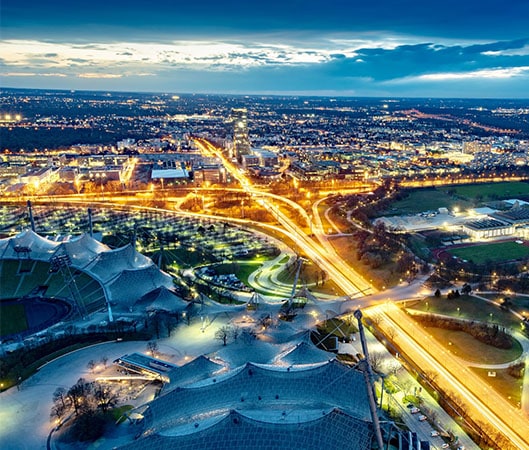 A city at night with roads illuminated by streetlights