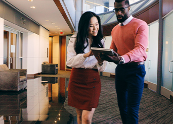 man and woman looking at a tablet together